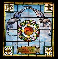 Satterlee Memorial Window: two doves hovering above a flowering wreath with a Byzantine cross Satterlee Memorial Window: two doves hovering above a flowering wreath with a Byzantine cross
