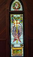 Armstrong Memorial Window: haloed cross, enveloped by two wings Armstrong Memorial Window: haloed cross, enveloped by two wings