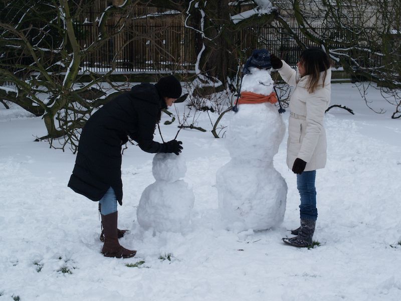 making snow men in front of King's College, Cambridge, England