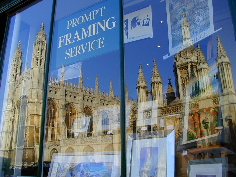 Cambridge, England: King's College: chapel, screen and gatehouse reflected in shop window