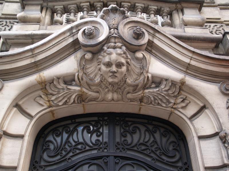 Paris, France: 60 Rue Lecourbe: sculpture over door of woman (1900, architect Henri Ragache)