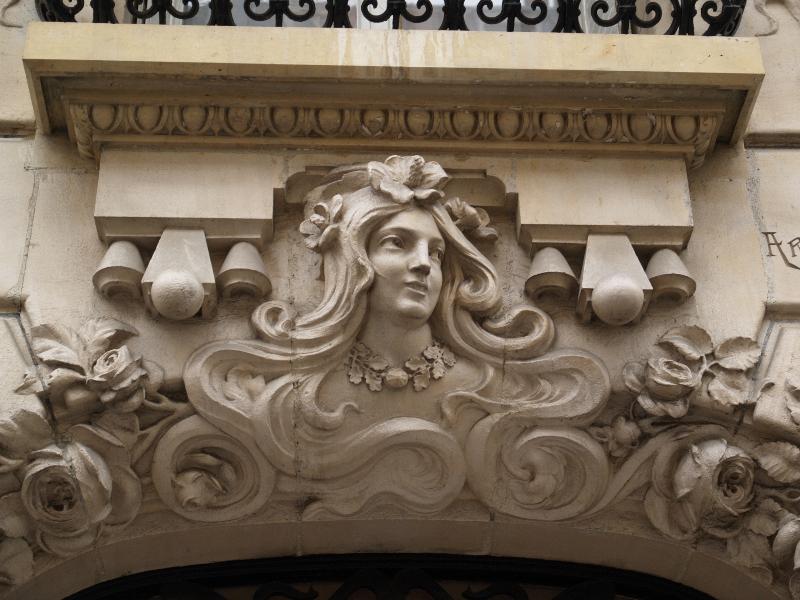 Paris, France: 10 Rue Valentin Hauy: sculpture over door of woman (1904, architect Paul Denis)