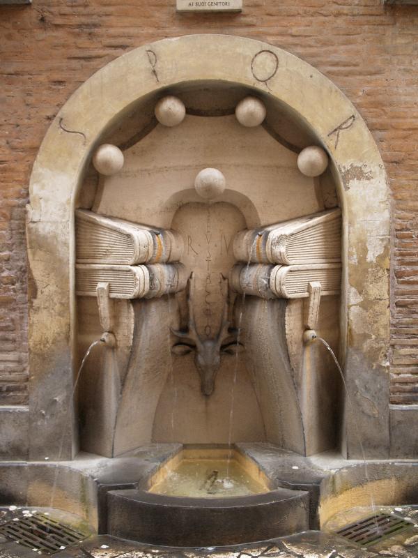 Rome, Italy: Via degli Staderari: fountain with books and stag's head decoration