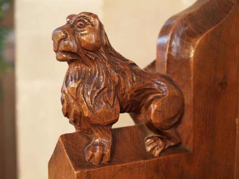 Cambridge, England: St Andrew's Church, Chesterton: oak bench carving of lion (?)