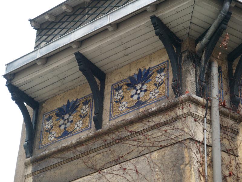 Paris, France: 4 Square de Montsouris: tile decoration below eaves