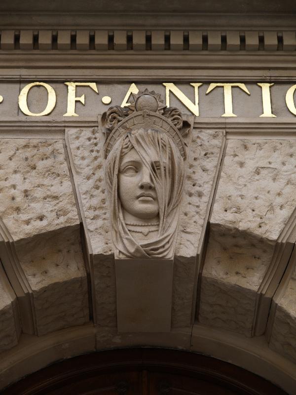 London, England: Piccadilly, Burlington House, Society of Antiquaries: head of woman over entrance (1869-1873, architects Robert Richardson Banks and Charles Barry, Jr.)