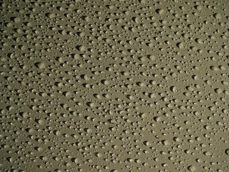 Cambridge, England: Roseford Road: water drops on smooth metallic surface