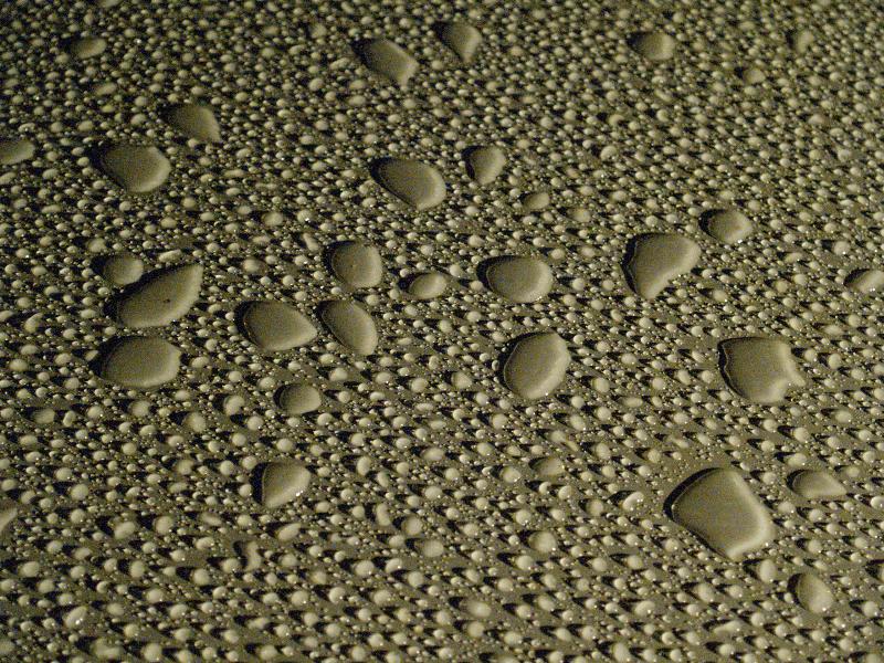 Cambridge, England: Roseford Road: water drops on smooth metallic surface
