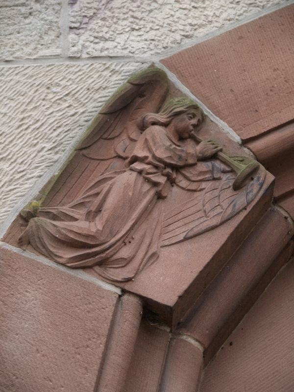 Ettlingen, Germany: Herz-Jesu Kirche: angel (part of door surround) (c1900)