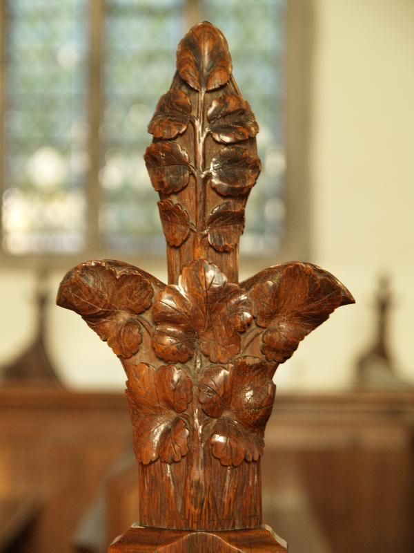 Cottenham, England: All Saints Church: pew bench carving (1867)