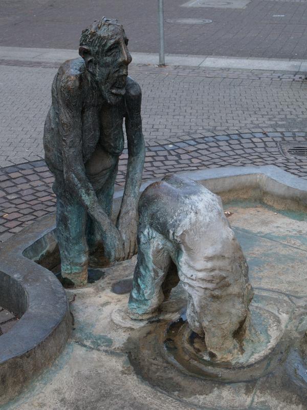 Karlsruhe, Germany: Lammstrasse: 'Jungbrunnen mit Vierdimensionalem Luftsprung', old man diving into water (Fountain of Youth, Fountain of the Lamb) (1983-1986, sculptor Karl-Henning Seemann)
