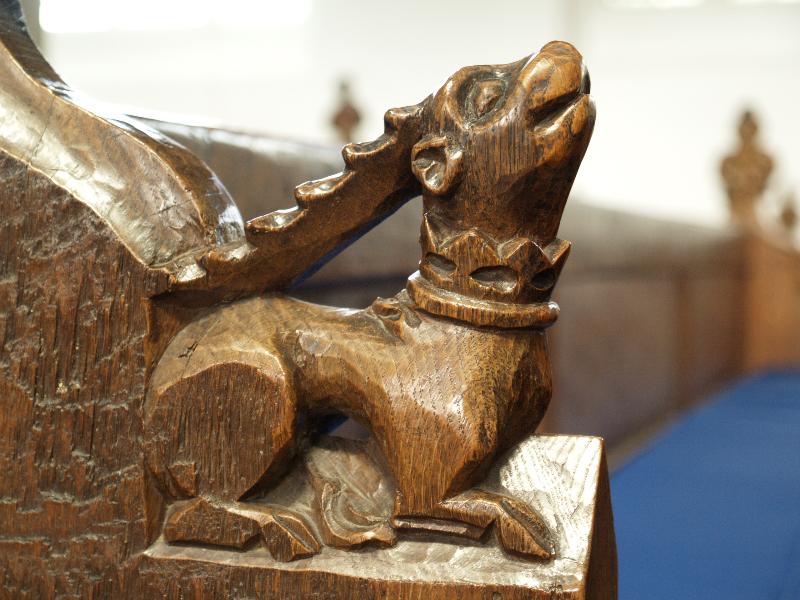 Cambridge, England: St Andrew's Church: oak bench carving of horned creature