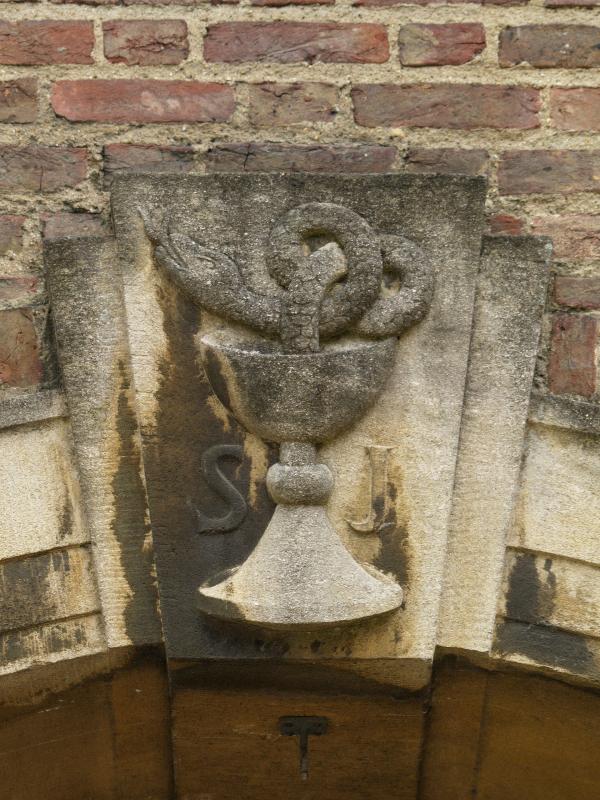 Cambridge, England: St John's College: keystone, snake in chalice (so poisoned chalice of St John) (1939, sculptor Eric Gill)