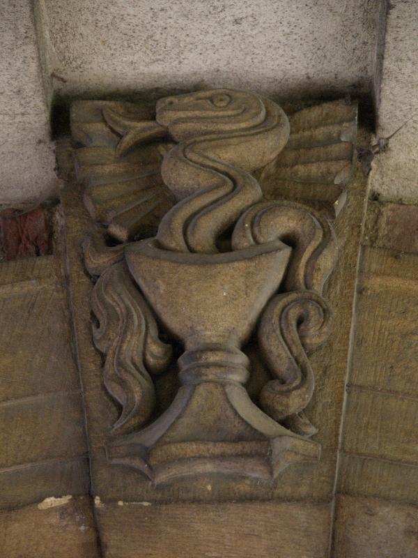 Cambridge, England: St John's College: keystone, snake in chalice (1939, sculptor Eric Gill)