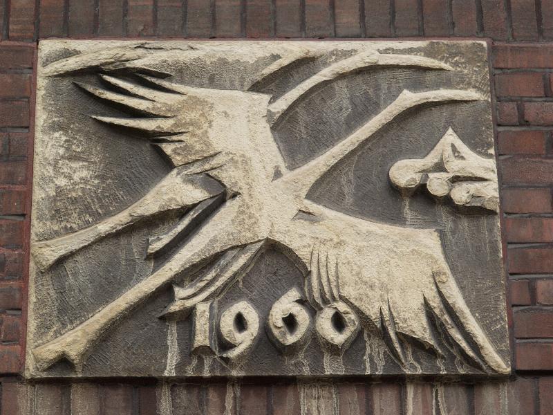 Munster, Germany: Bergstrasse 54: relief of storks (?) over door (1960)