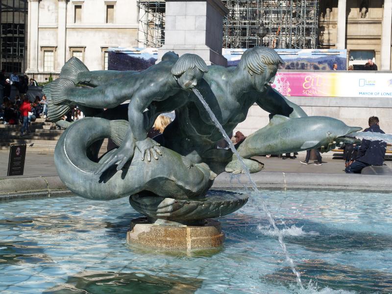 London, England: Trafalgar Square: west fountain merman and dolphin (1939, installed 1948, Charles Wheeler)