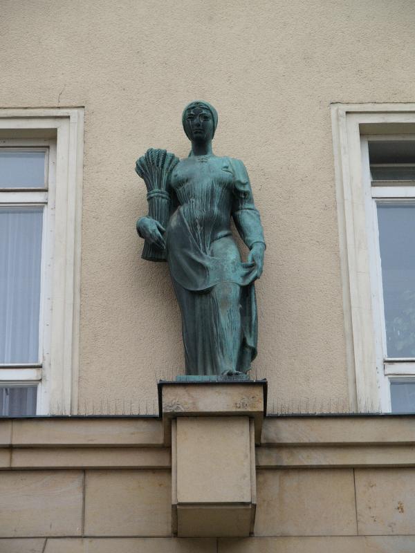 Brno, Czech Republic: Moravske namesti 4: woman with wheat (1920s?, Josef Kubicek)