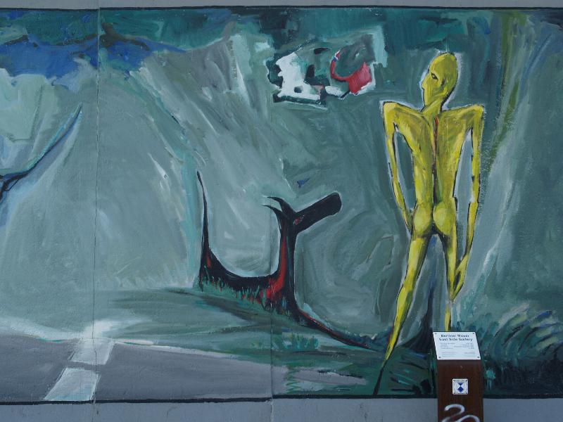 Berlin, Germany: East Side Gallery (Berlin Wall): man and dog (1990/2009, Peter Peinzger)