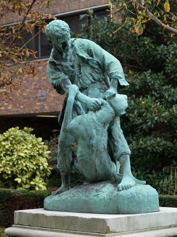Paris, France: Rue du Docteur Roux, Institut Pasteur: statue of dog biting boy (rabies) (foundry Perzinka)