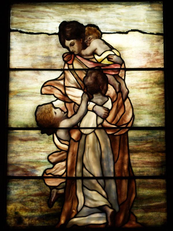 Tuxedo Park, New York (NY): St Mary's-in-Tuxedo Church: mother and children (Tiffany) (design based on Charity figure in Joshua Reynolds window in New College chapel, Oxford)