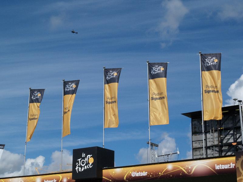 Cambridge, England: Parker's Piece: Tour de France, main stage signs and police helicopter