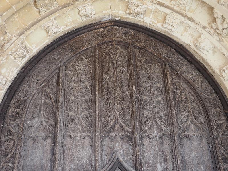 Clare, England: Church of St Peter and St Paul: top of door