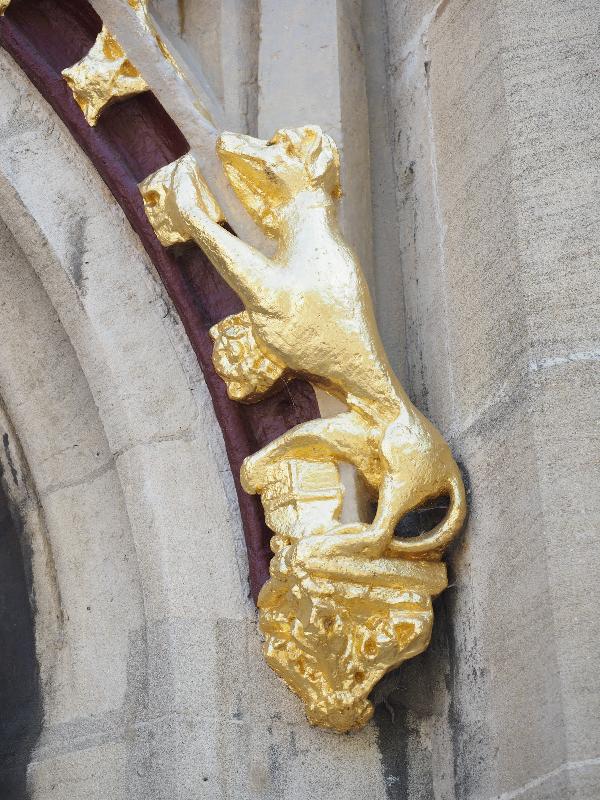 Cambridge, England: Christ's College: gate decoration, dog