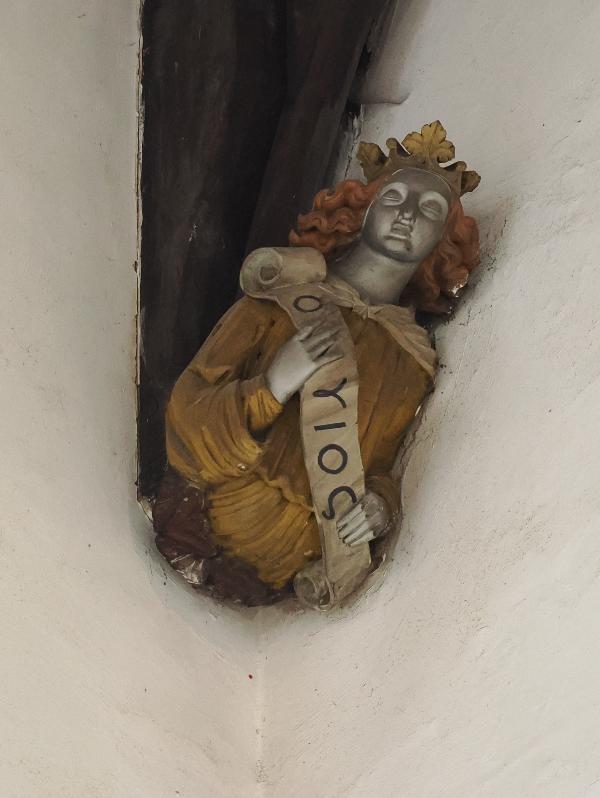 Cambridge, England: St Bene't's Church: north side of north aisle, figure with scroll text AGIOS (Holy)
