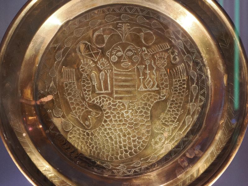 London, England: British Museum: brass dish, possibly showing Mami Wata (1850-1900, manufactured in UK, decorated by Efik women living in the Cross River area, southern Nigeria)