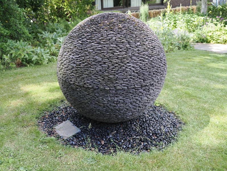 Cambridge, England: Fitzwilliam College: Dark Planet (presented 2015; sculptor David Harber)