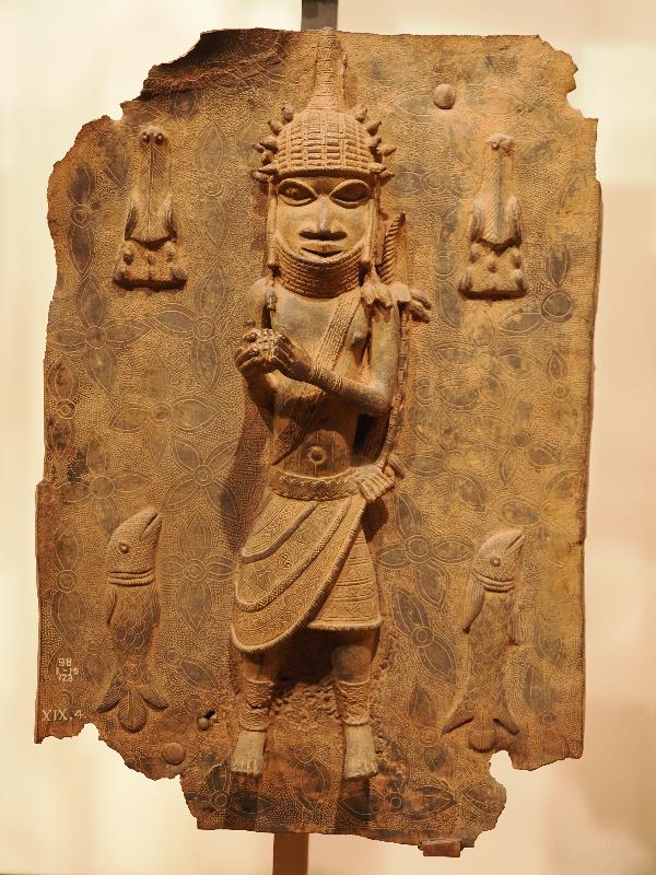 London, England: British Museum: cast brass plaque, man and two fish (16th century, Benin, Nigeria)