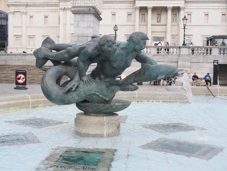London, England: Trafalgar Square: west fountain merman and dolphins (1939, installed 1948, William McMillan)