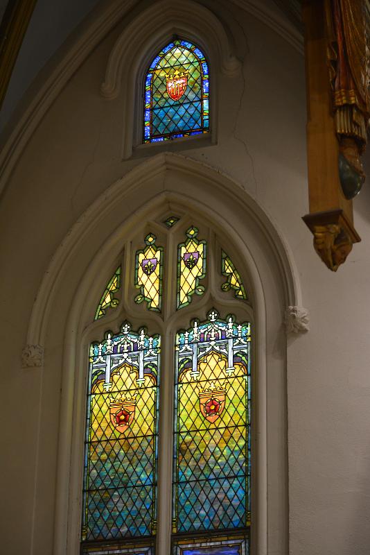 three ornamental windows, one larger and two smaller