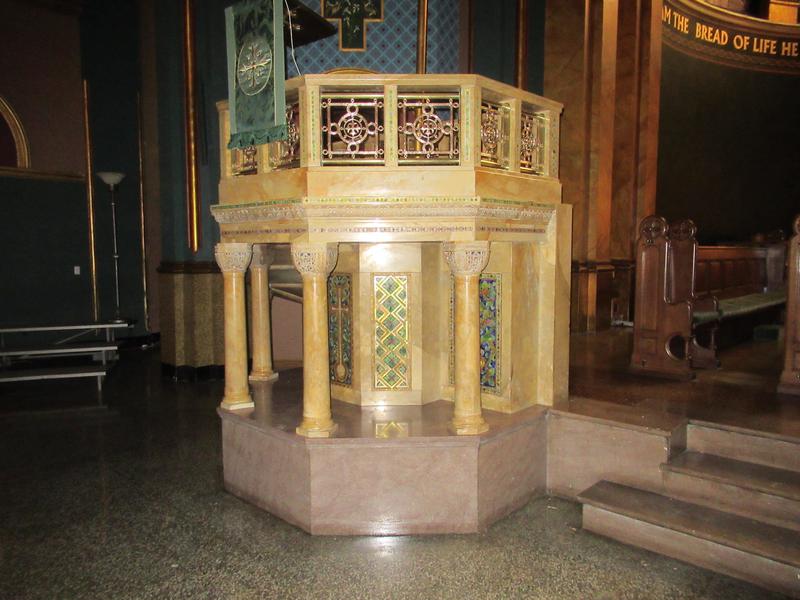 pulpit in colored marble and mosaic with a brass rail