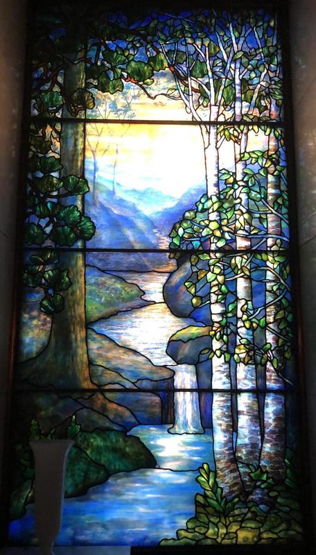 Schram Memorial Window:  landscape with conifers at left, birch trees at right, mountains and water