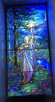 Illinois, Chicago, Rosehill Cemetery, Community Mausoleum: Seaver Memorial Window:  female figure holding aloft a blazing torch standing by creek in wooded area
